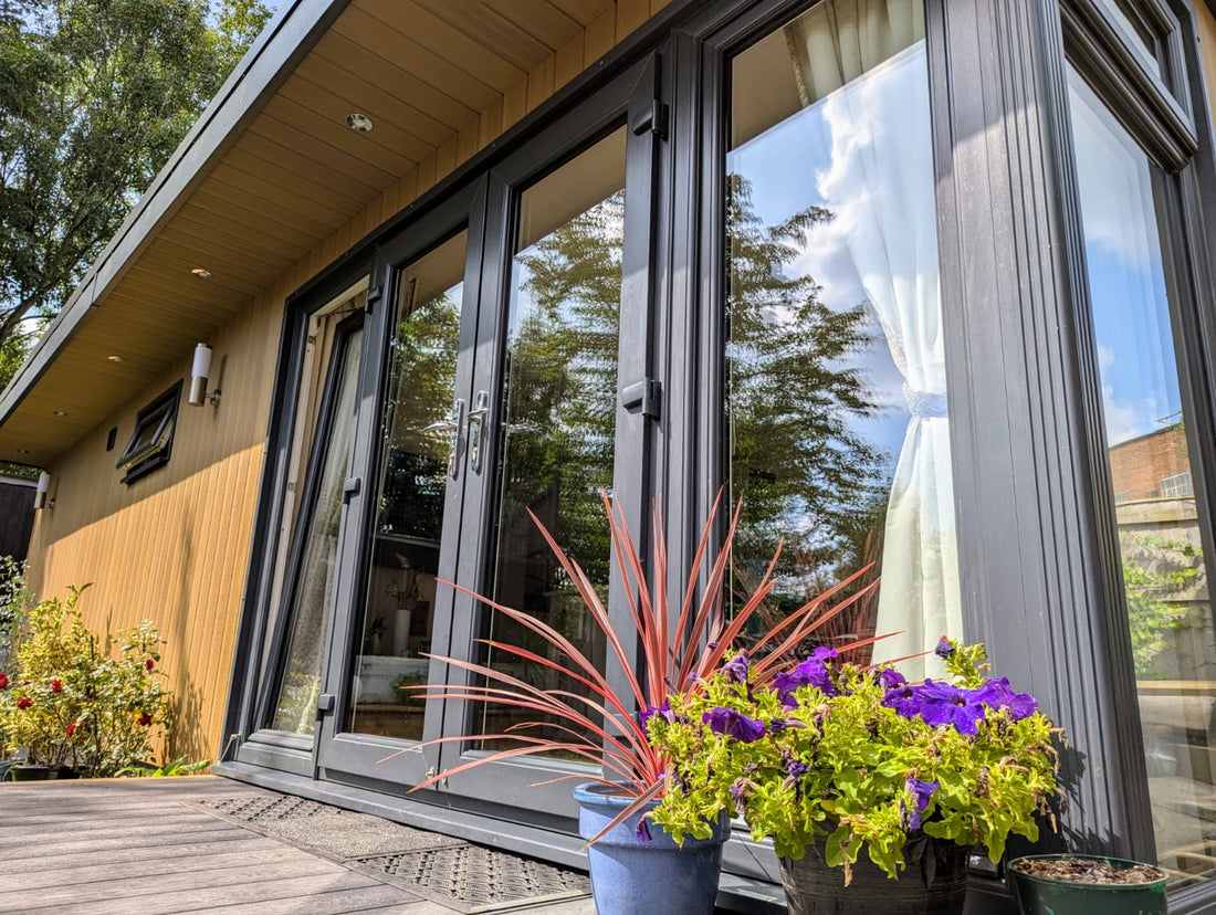 A Garden Annexe with French Doors, two side windows and a canopy across the front of the building.