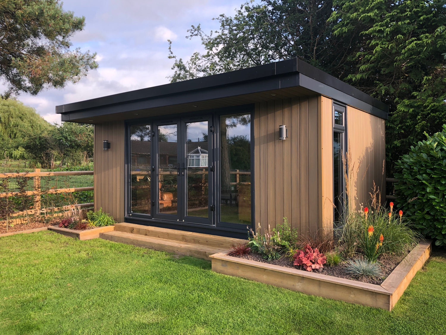 A contemporary garden room office in north wales with garden planters