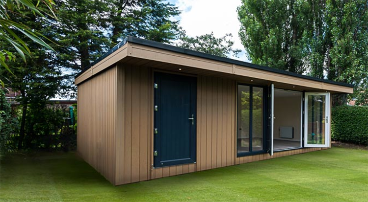 A garden shed in the middle of a lawn.