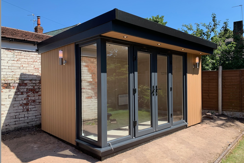 A garden room with a door and windows.