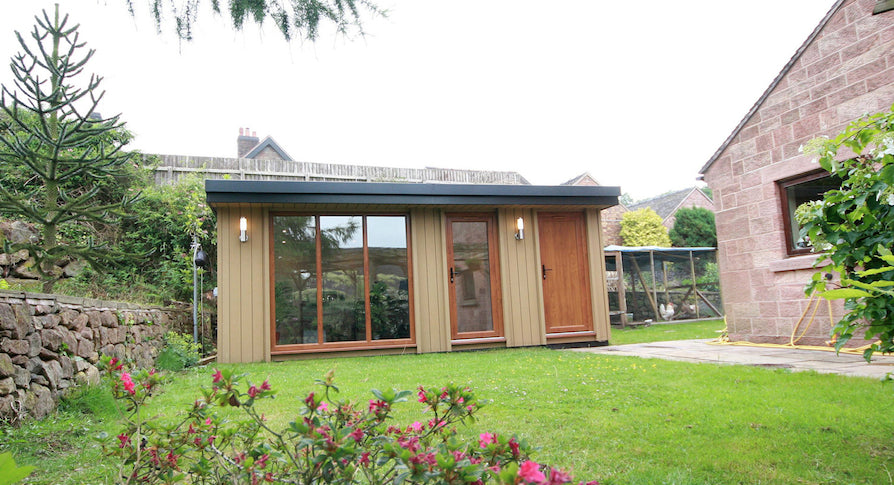 A small house with a garden in the back yard.