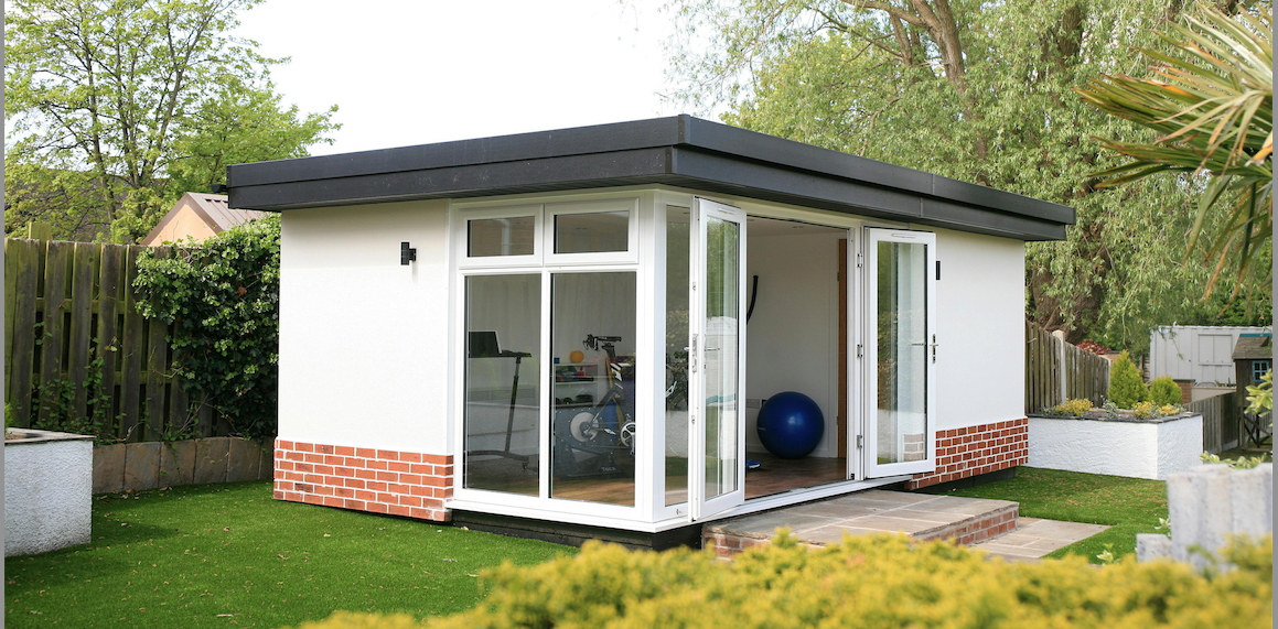 A small home gym with a glass door.