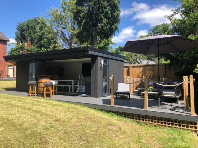 A garden room office in Bangor, North Wales with large veranda and outdoor seating area