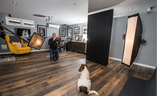 A man and a dog in a photo studio.