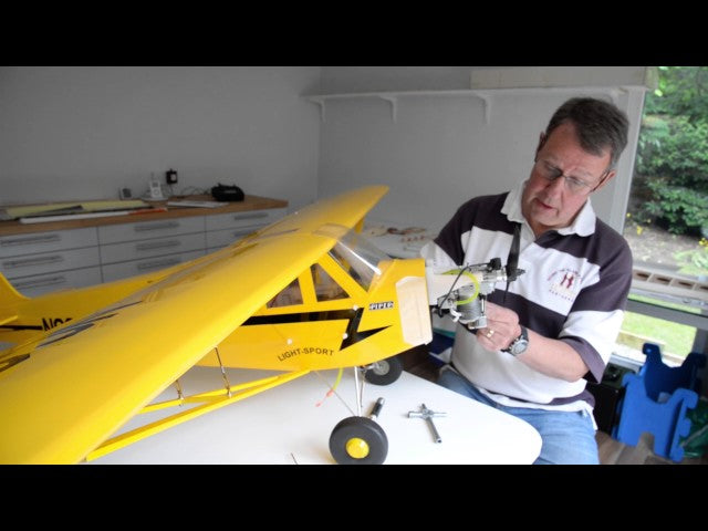 Load video: A man works on his model aeroplane in a garden room in Manchester