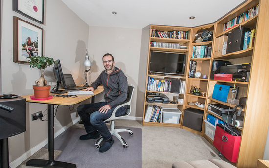 A man sitting at a desk in his home office.