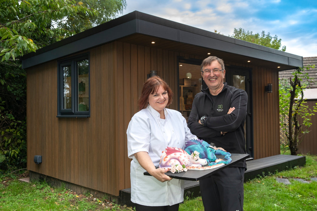 Outisde the garden room, with Baker Helen holding her cake, alongside Director of Rubicon, John Lyon.