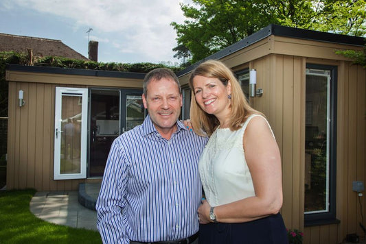 Two people outside a garden office on the Wirral, Cheshire 