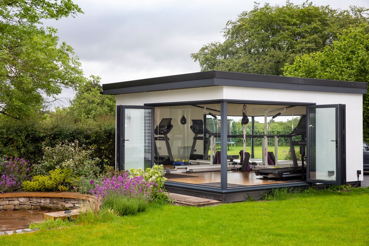 A garden room office in Stockport with gym and mirrored walls