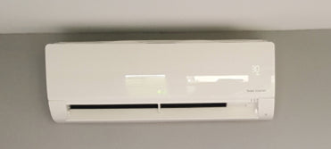 A white air conditioner hanging from the ceiling.