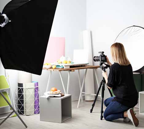A woman is taking a photo in a studio.