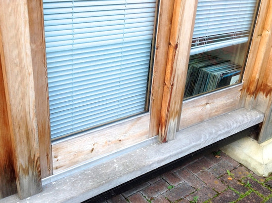 A wooden window with blinds.