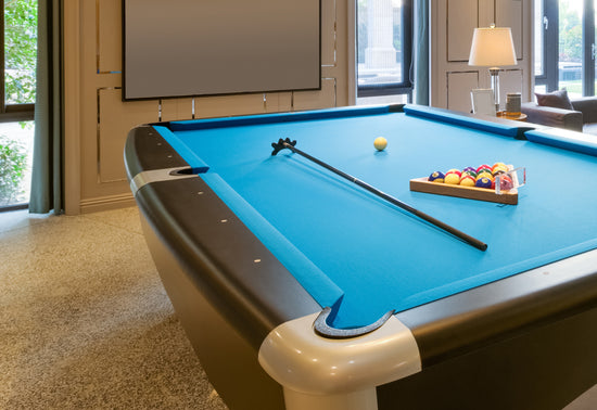 A pool table in a living room.