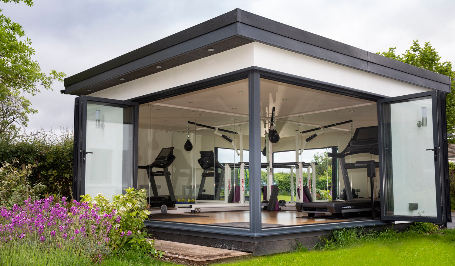 A garden room office gym in Liverpool with double bi fold doors and mirrored walls