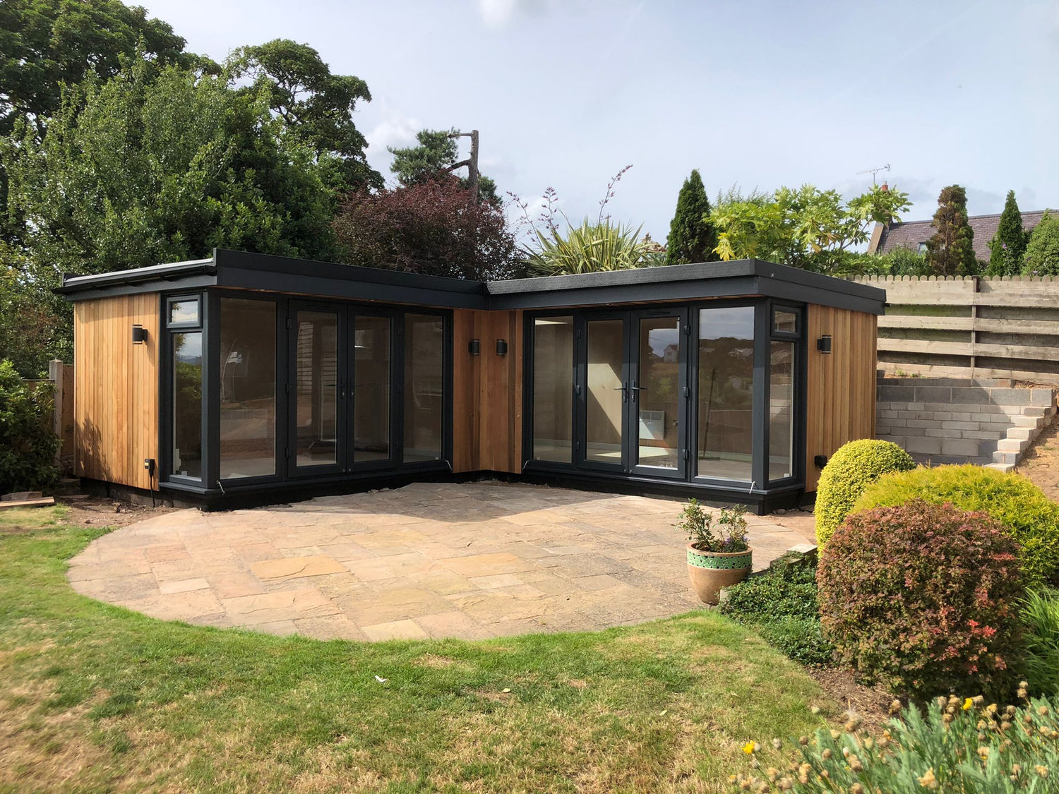 A corner garden room office in Crewe with cedar cladding 