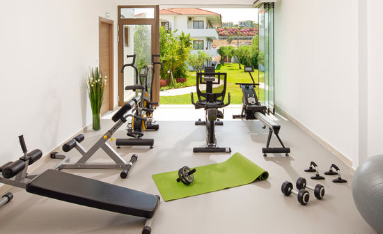 A gym room with a variety of equipment.