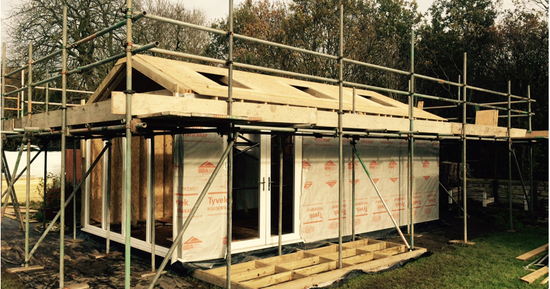 A house being built with scaffolding and scaffolding.