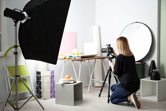 A woman is taking a photo in a studio.